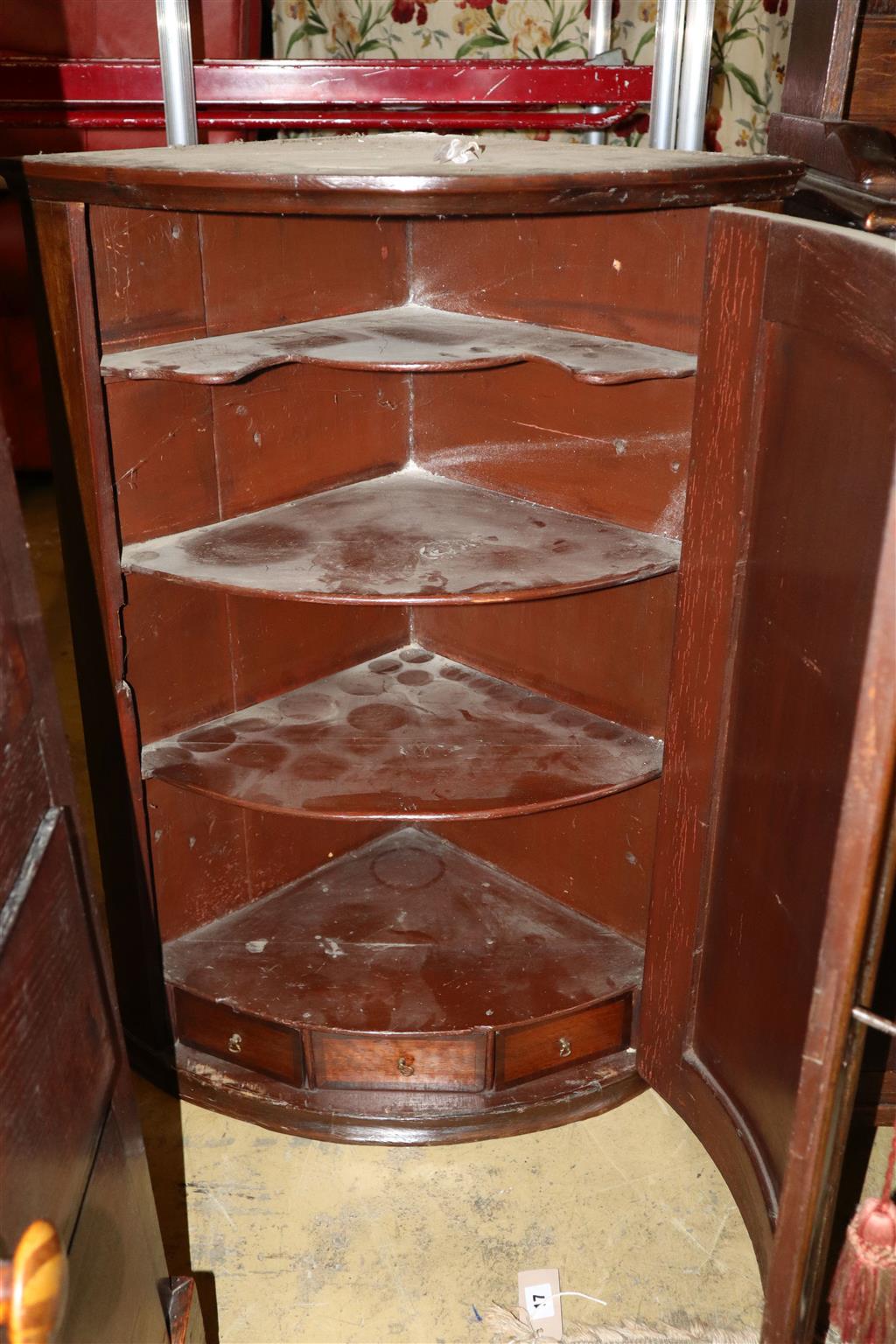 A George III walnut bowfront hanging corner cabinet, width 62cm, depth 42cm, height 88cm